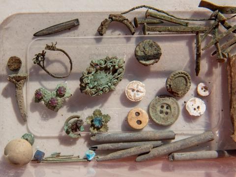 A close up of some of the old artefacts that were found at Blues Point construction site. Buttons, nails and screws are amongst the items found.
