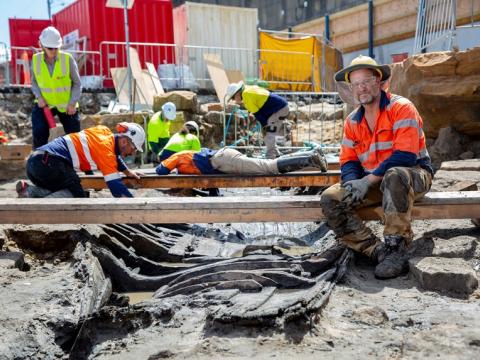 Archaeologists in high vis and hard hats are working in the excavation area at the future site of Barangaroo Metro Station.