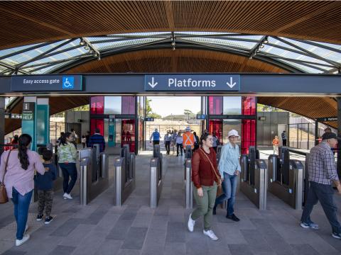 Cherrybrook Metro station pictured from the entrance with patrons walking in and out of opal gates