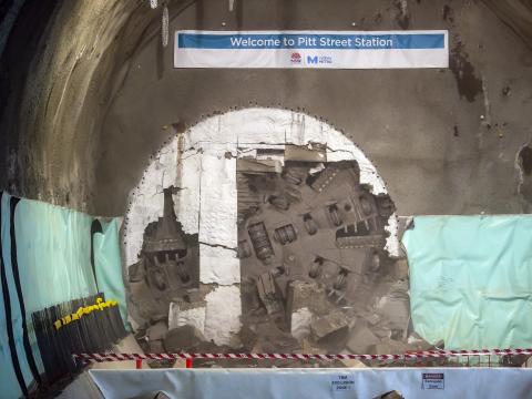 The cutterhead of a tunnel boring machine can be seen breaking through the wall at Pitt Street Station