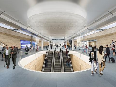 Artist's impression of commuters walking around inside the new Sydney Metro Central Station entrance at the top of the escalators.