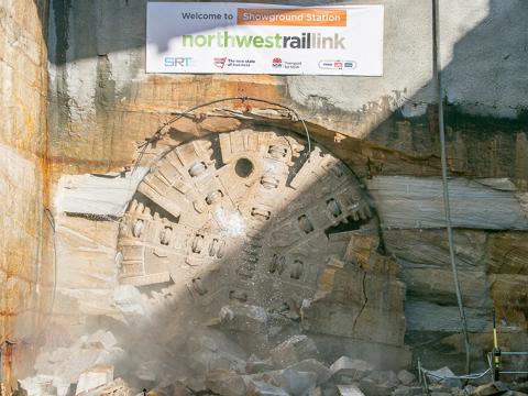 An on the ground view showing Tunnel Boring Machine (TBM) 1 Elizabeth final break through the stone at Sydney Metro's Hills Showground Station. 
