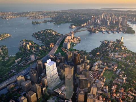 An artist's impression showing a bird's eye view of Sydney Metro's Victoria Cross Station highlighted in white, with surrounding suburbs of North Sydney, Sydney Harbour bridge and Sydney harbour in colour. 