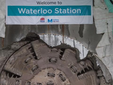 Tunnel Boring Machine (TBM) Nancy breakthrough with a banner displaying Sydney Metro's Waterloo Station. 