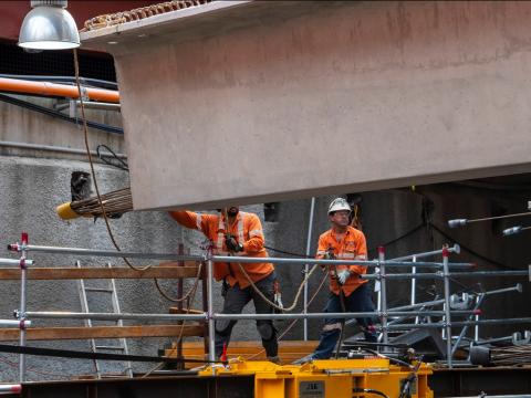Workers installing precast beams in the Barangaroo Station box
