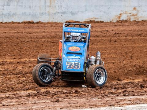 A blue race car spins out in the dirt track at the new Eastern Creek Speedway.
