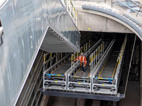 A construction worker attaches ones section of escalators to another at Central Station.