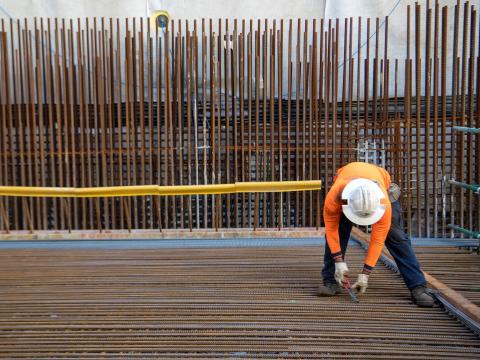 Construction worker installing metal rods at Sydney Metro's Crows Nest Station.
