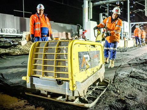Construction worker using a concrete levelling machine at Sydney Metro's Chatswood Station