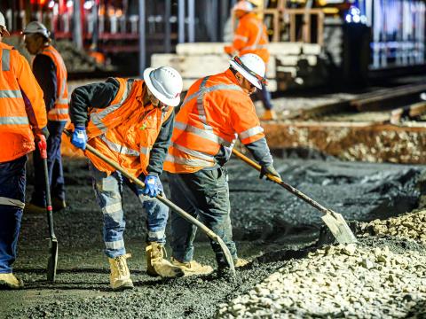 Construction workers laying concrete at Sydney Metro's Chatswood Station