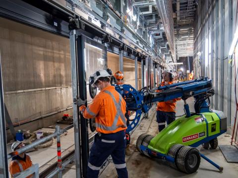Construction workers installing platform screen doors at Sydney Metro's Waterloo Station