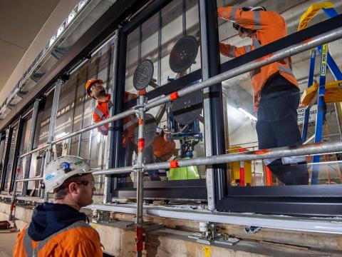 Construction workers installing platform screen doors