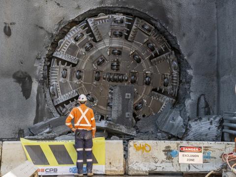 a worker standing in front of TBM Peggy