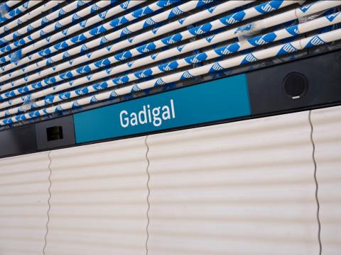 Signage of Gadigal station  in white letters on blue background, which is Sydney Metro's brand color