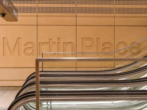 The words Martin Place indented on a wall at the station
