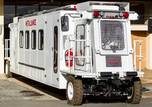 A white specialised 4WD vehicle that takes tunnel workers  to the tunnel boring machines underground.