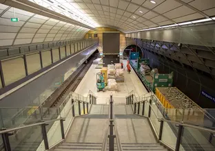 An arial view looking down the station stairs at the platform where a freight train delivering materials to the platform at East Coast Rail Link's Macquarie Park Station.