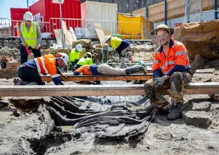 Archaeologists in high vis and hard hats are working in the excavation area at the future site of Barangaroo Metro Station.