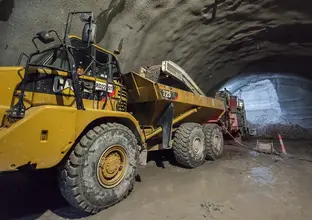 An on the ground view inside the tunnel at Sydney Metro's Pitt Street North construction site with a close up shot of a Roadheader inside the tunnel. 