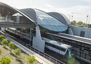 An aerial view of a metro train departing Tallawong Metro Station.