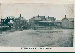 An old black and white photo of Sydenham Railway Station in circa 1910. The title 'Sydenham Railway Station' is at the bottom of the image.