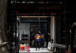 On the ground view of construction worker looking up at Sydney Metro's Victoria Cross Station North Cavern.