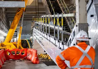 Construction worker installing escalators at Barangaroo Station.