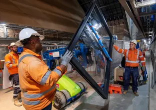 Construction workers installing platform screen doors at Central Station.