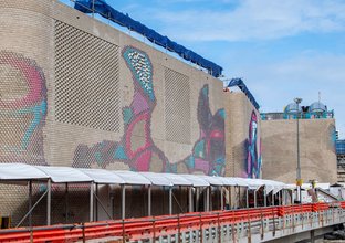 Colourful aboriginal artwork covers the brick ventilation buildings at Central Station.
