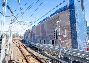 Colourful aboriginal artwork covers the brick ventilation buildings along the tracks at Central Station.
