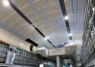 Low angle shot of mezzanine area and underground cavern ceiling at Sydney Metro's Victoria Cross Station.