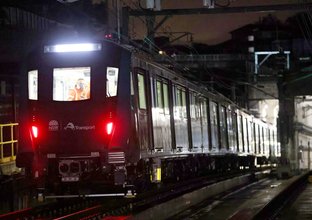 A metro train drives at night during train testing for the City & Southwest project.