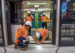 Train door and platform door is being measured and tested by engineers