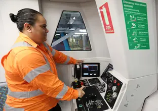 A women in bright colored PPE testing the train in the operating room