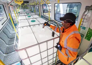 Passenger simulation testing by a worker in bright orange PPE on the Sydney Metro City & Southwest line