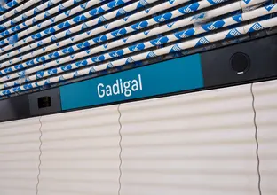Signage of Gadigal station in white letters on blue background, which is Sydney Metro's brand color