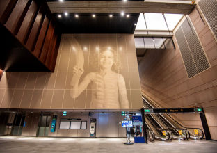 Artwork at Waterloo Station depicting an Aboriginal child, rich in cultural symbolism, with vibrant colors and traditional elements that celebrate Indigenous heritage and the spirit of a young community member