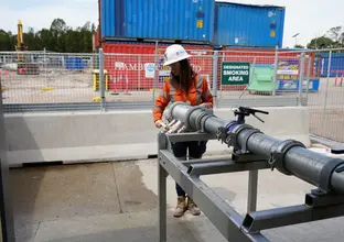 One apprentice working at the construction site wearing PPE
