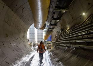 A worker is exiting a tunnel at The Bays