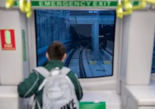 a young boy looking at the tracks from the newly opened city line metro