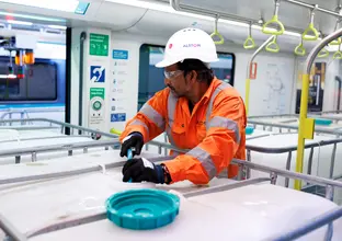 Construction worker loading a water cannister
