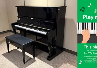 Piano at Martin Place station showing the 'Play me!' banner