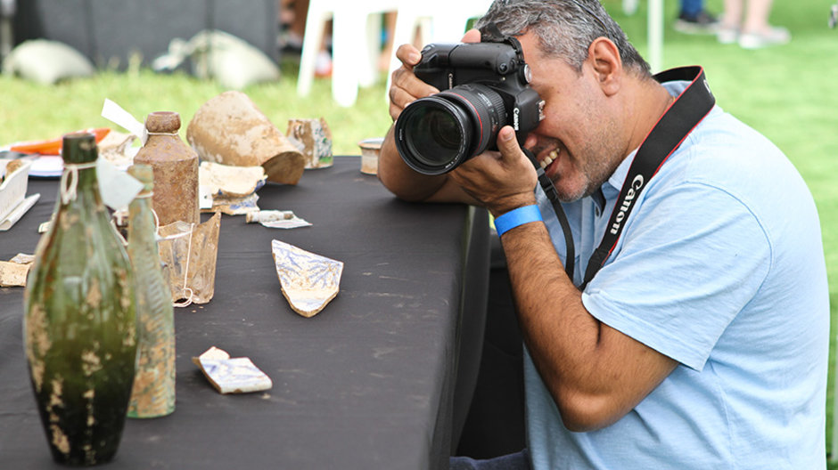 Man photographing artefacts