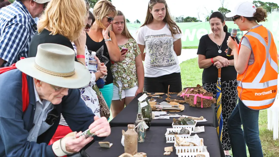 Community members looking at artefacts