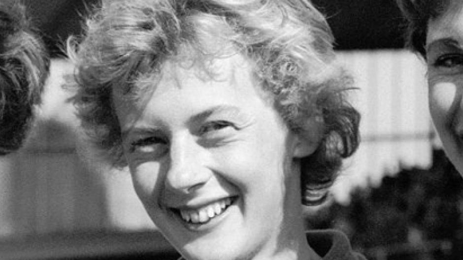 A young Betty Cuthbert with short hair, smiling