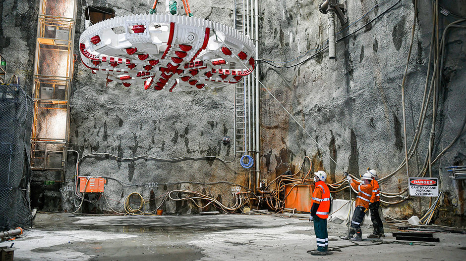Barangaroo TBM 5 Cutterhead being observed by three construction workers.