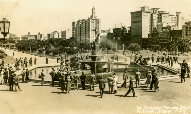 Sepia coloured photo of people gathering at the Archibald Fountain in Hyde Park North, c.1930. 