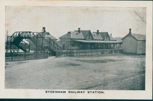 An old black and white photo of Sydenham Railway Station in circa 1910. The title 'Sydenham Railway Station' is at the bottom of the image.