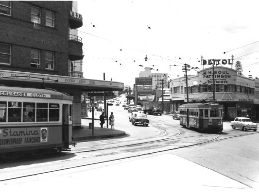 Black and white photo of trams and cars travelling on the Pacific Highway, North Sydney