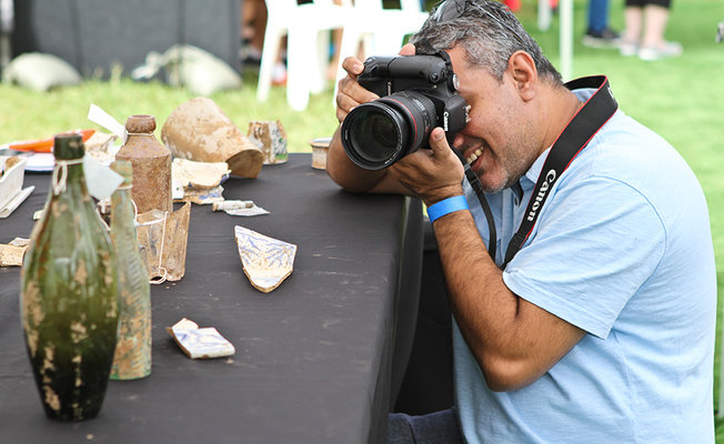 Man photographing artefacts